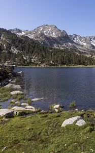 Preview wallpaper pond, mountains, grass, stones, landscape, nature