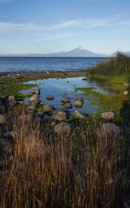 Preview wallpaper pond, stones, sea, volcano, nature