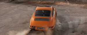 Preview wallpaper porsche, car, rear view, sand, road