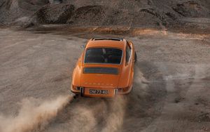 Preview wallpaper porsche, car, rear view, sand, road