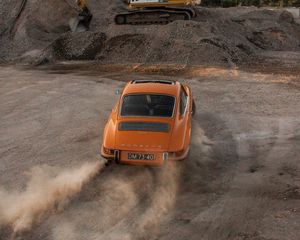 Preview wallpaper porsche, car, rear view, sand, road