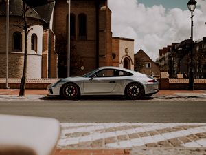 Preview wallpaper porsche, car, silver, road, buildings, architecture