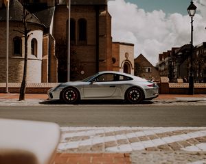 Preview wallpaper porsche, car, silver, road, buildings, architecture