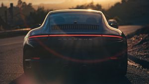 Preview wallpaper porsche, sports car, rear view, black, sunlight, movement