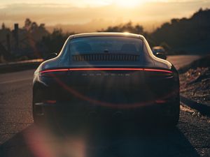 Preview wallpaper porsche, sports car, rear view, black, sunlight, movement