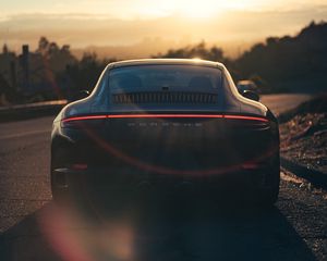 Preview wallpaper porsche, sports car, rear view, black, sunlight, movement