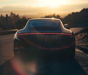 Preview wallpaper porsche, sports car, rear view, black, sunlight, movement