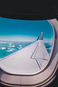 Preview wallpaper porthole, airplane, wing, sky