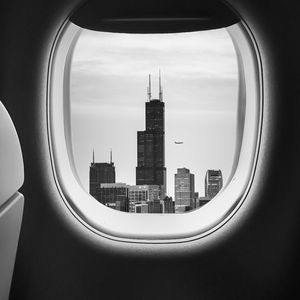 Preview wallpaper porthole, bw, airplane window, buildings, flight