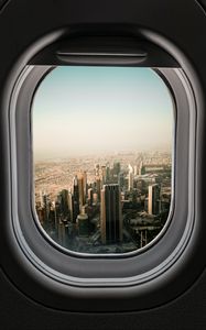 Preview wallpaper porthole, city, skyscrapers, aerial view, window