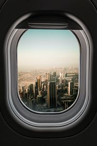 Preview wallpaper porthole, city, skyscrapers, aerial view, window