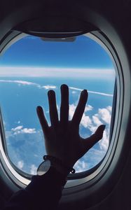 Preview wallpaper porthole, hand, airplane, window, clouds