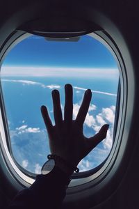 Preview wallpaper porthole, hand, airplane, window, clouds