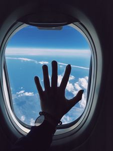 Preview wallpaper porthole, hand, airplane, window, clouds