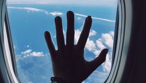 Preview wallpaper porthole, hand, airplane, window, clouds