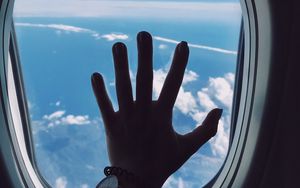 Preview wallpaper porthole, hand, airplane, window, clouds