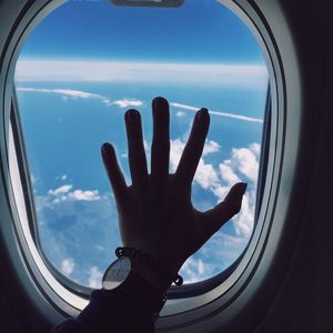 Preview wallpaper porthole, hand, airplane, window, clouds