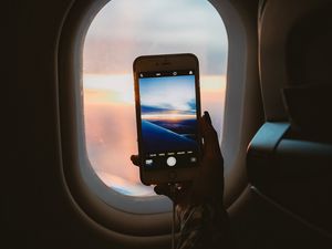 Preview wallpaper porthole, hand, phone, photo, window, view