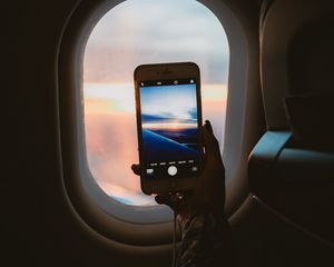 Preview wallpaper porthole, hand, phone, photo, window, view