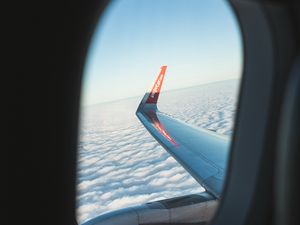 Preview wallpaper porthole, window, plane, wing, clouds, view