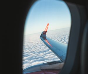 Preview wallpaper porthole, window, plane, wing, clouds, view