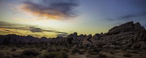 Preview wallpaper prairie, rocks, trees, bushes, sunset