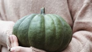 Preview wallpaper pumpkin, hands, sweater, autumn