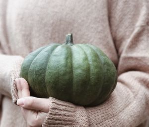 Preview wallpaper pumpkin, hands, sweater, autumn