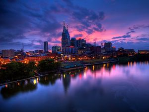 Preview wallpaper purple sunset, city, buildings, skyscrapers, beach, night, river