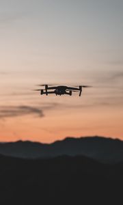 Preview wallpaper quadcopter, drone, flight, mountains, silhouette, sunset
