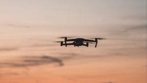 Preview wallpaper quadcopter, drone, flight, mountains, silhouette, sunset