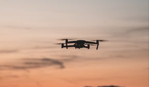 Preview wallpaper quadcopter, drone, flight, mountains, silhouette, sunset