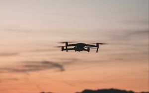 Preview wallpaper quadcopter, drone, flight, mountains, silhouette, sunset