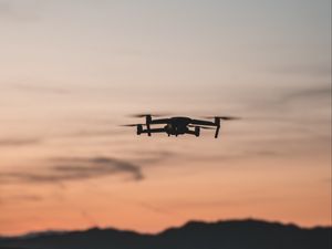 Preview wallpaper quadcopter, drone, flight, mountains, silhouette, sunset