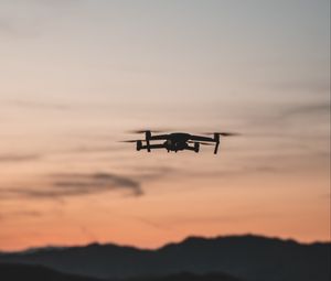 Preview wallpaper quadcopter, drone, flight, mountains, silhouette, sunset