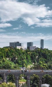 Preview wallpaper railroad, train, buildings, trees, city