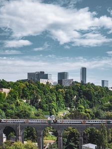 Preview wallpaper railroad, train, buildings, trees, city