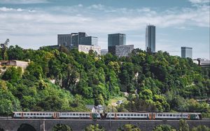 Preview wallpaper railroad, train, buildings, trees, city