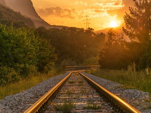 Preview wallpaper railroad, trees, sunlight, sunset