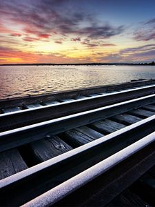 Preview wallpaper rails, cross ties, railway, sea, evening, clouds