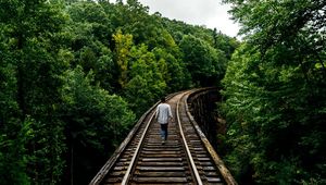 Preview wallpaper railway, man, walk, trees