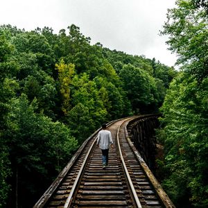 Preview wallpaper railway, man, walk, trees