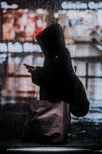 Preview wallpaper rain, silhouette, hood, drops