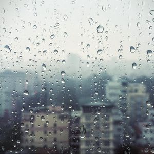 Preview wallpaper rain, window, glass, buildings, drops