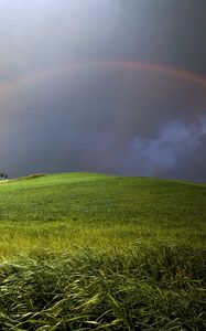 Preview wallpaper rainbow, field, meadow, hill, construction, cloudy