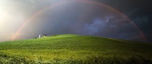 Preview wallpaper rainbow, field, meadow, hill, construction, cloudy