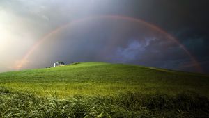 Preview wallpaper rainbow, field, meadow, hill, construction, cloudy