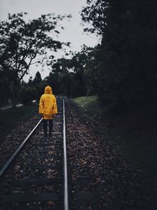 Preview wallpaper raincoat, man, railway, lonely, autumn, yellow