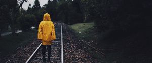 Preview wallpaper raincoat, man, railway, lonely, autumn, yellow