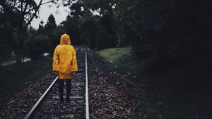 Preview wallpaper raincoat, man, railway, lonely, autumn, yellow